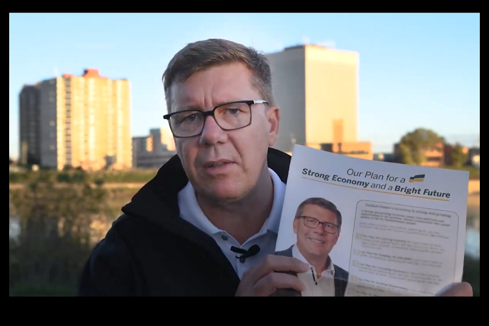 In a Sask Party video, Scott Moe shows a copy of the Sask Party platform that will be mailed out to voters.