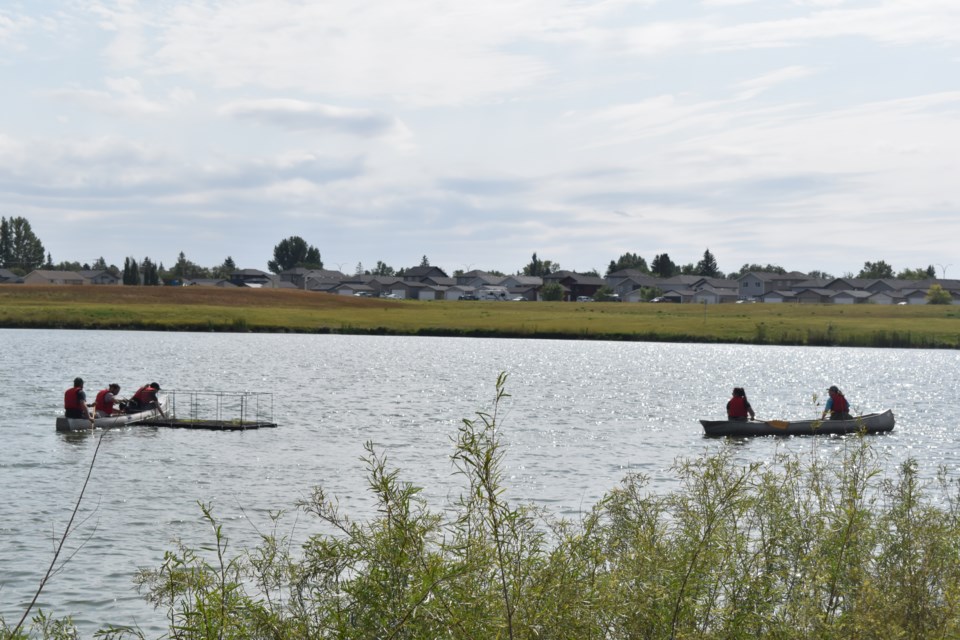 Volunteers install the floating treatment wetlands one at a time.