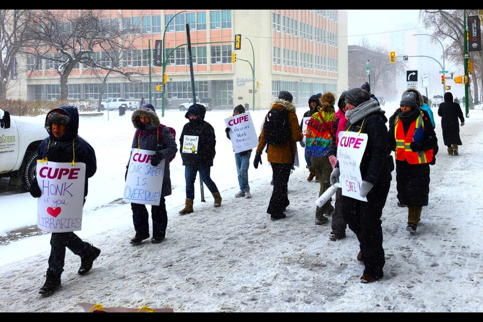 Library workers from CUPE 2669 continued their protest despite the inclement weather.