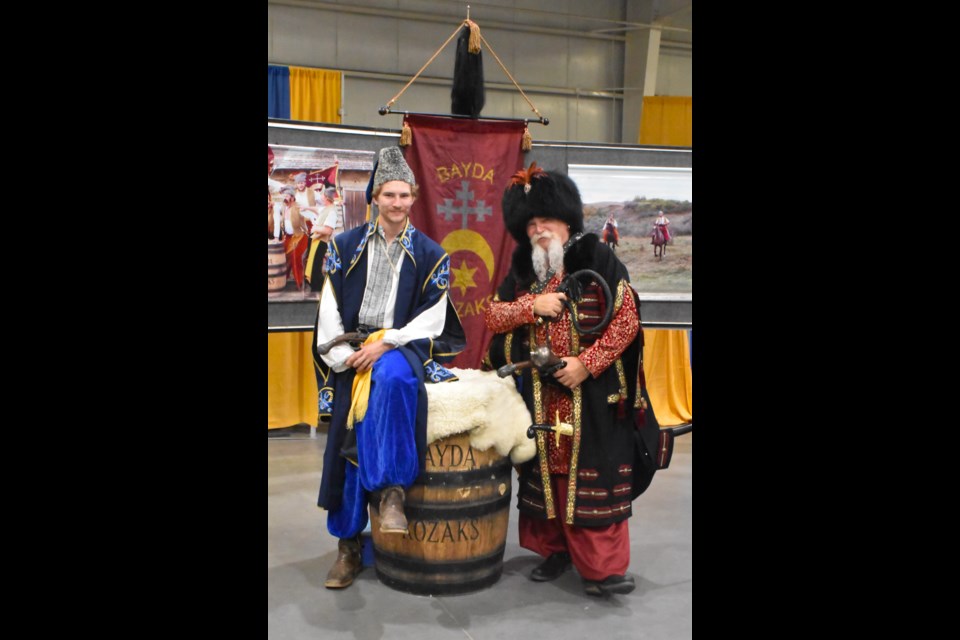 Two men dressed as Cossack warriors.