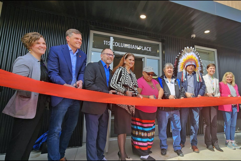 Elders Barb and Frank Badger, fifth and sixth left, join in the ribbon-cutting СƵ.