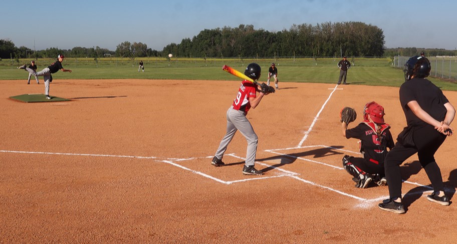 13U Canora Reds pitcher Kasen Heshka threw one right over the plate past a Yorkton batter to catcher Kenzee Kopelchuk during the July 13 tournament in Canora.