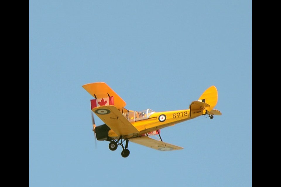 Norbert Glatt’s 1942 Tiger Moth flew overhead during a flag raising СƵ at Unity's Canada Day activities, with Canadian flags mounted on each side of the plane.