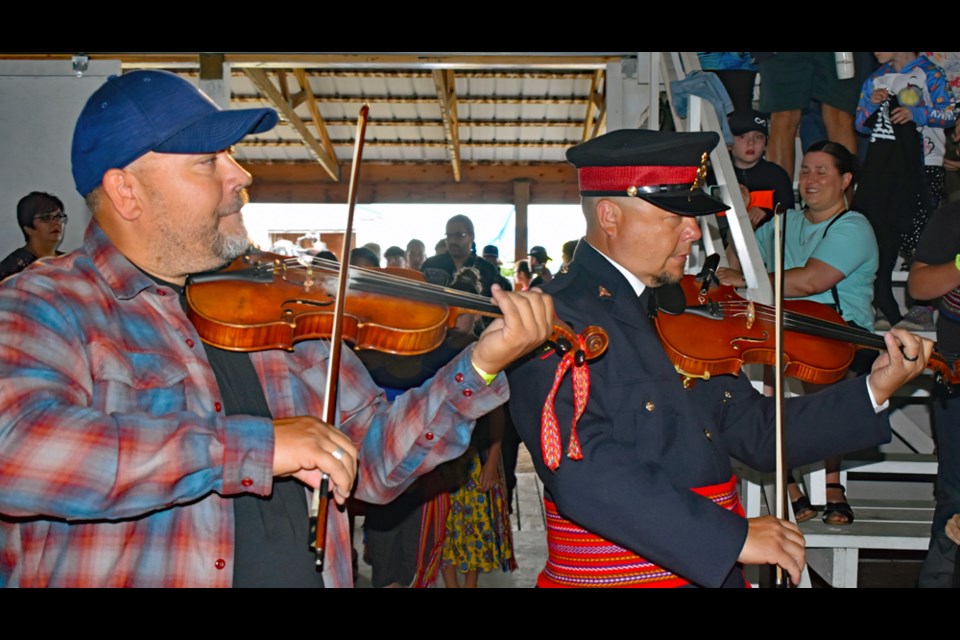 Fiddlers begin the festivities as they make their way into the hall.