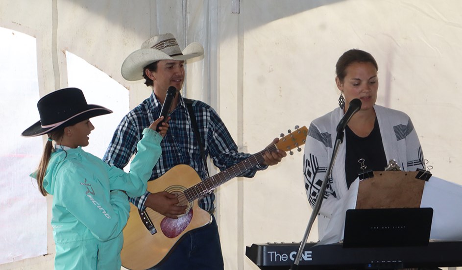 Aided by their daughter Emma holding a mic, Kelvin and Jessica Young led the singing during Cowboy Church at Ag Days on Aug. 25.