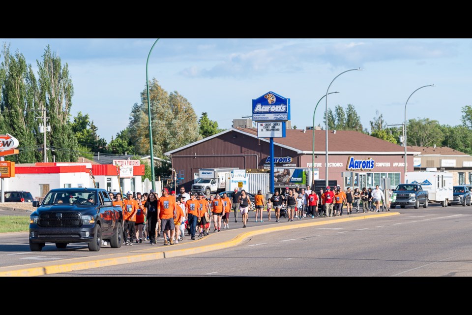 Walkers on 100th Street nearing Territorial Place Mall.