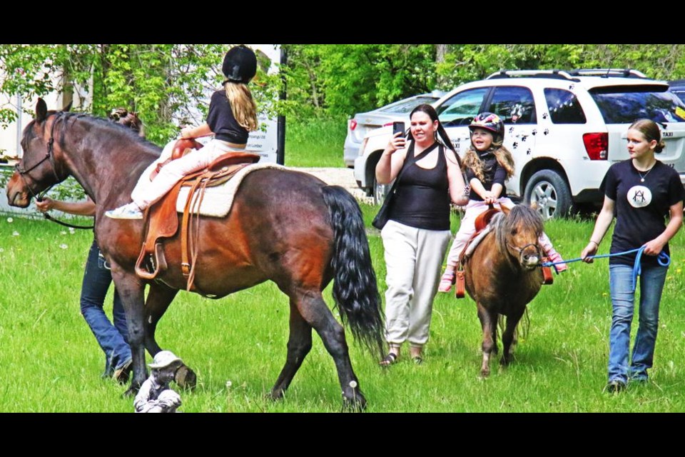 Sisters Gabriella, on the horse at left, and Eden enjoyed rides at the Weyburn Therapeutic Animal Park on Sunday.