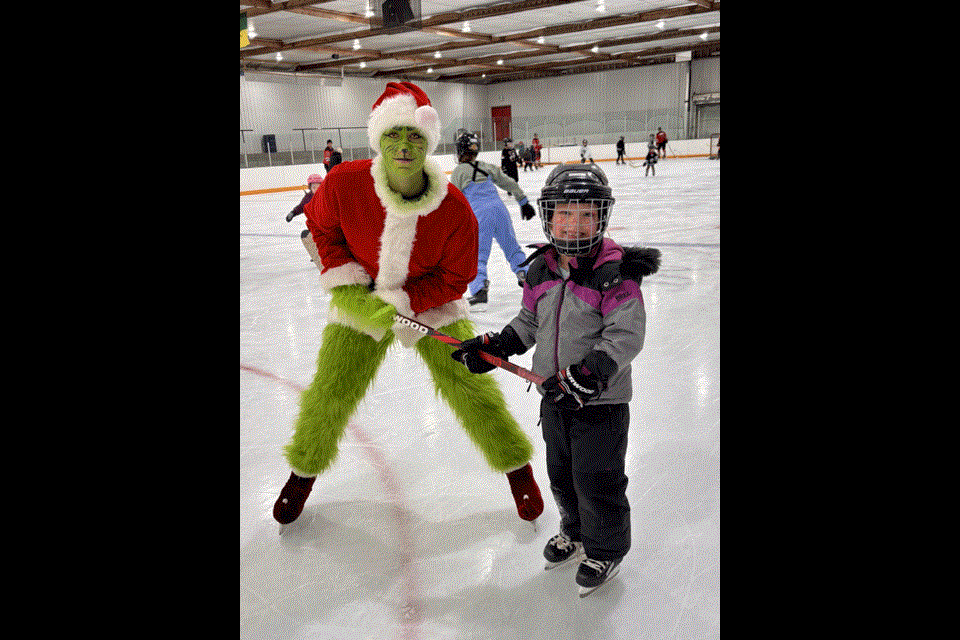 from left, Brittany Yates ran the streets while dressed as the Grinch, stealing candy from the kids and later hockey with Quinn Miller