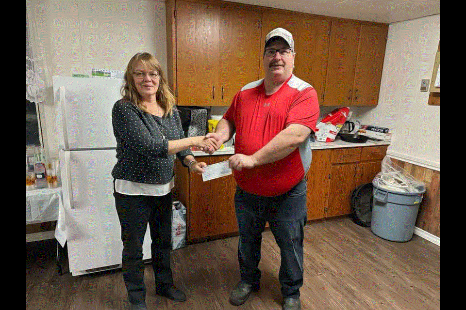 From left, Theresa Luedtke from the Carlyle and District Foodbank received a cheque from Paul Delalleau from the Moose Mountain Wildlife Federation