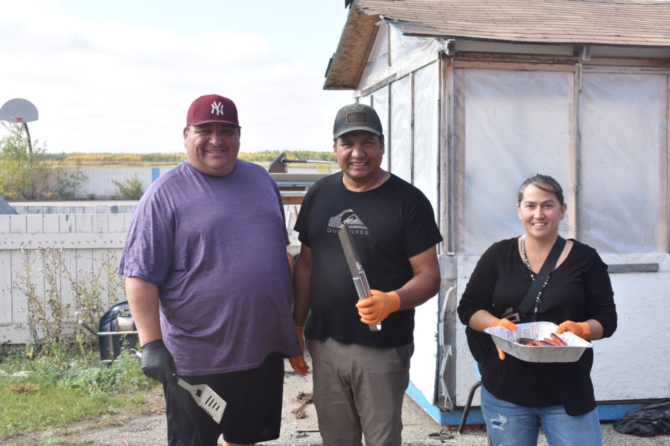 From left, Allen Cote, Ashley Straightnose, and Rebecca Konowalchuk were the volunteer barbecuers for the day.