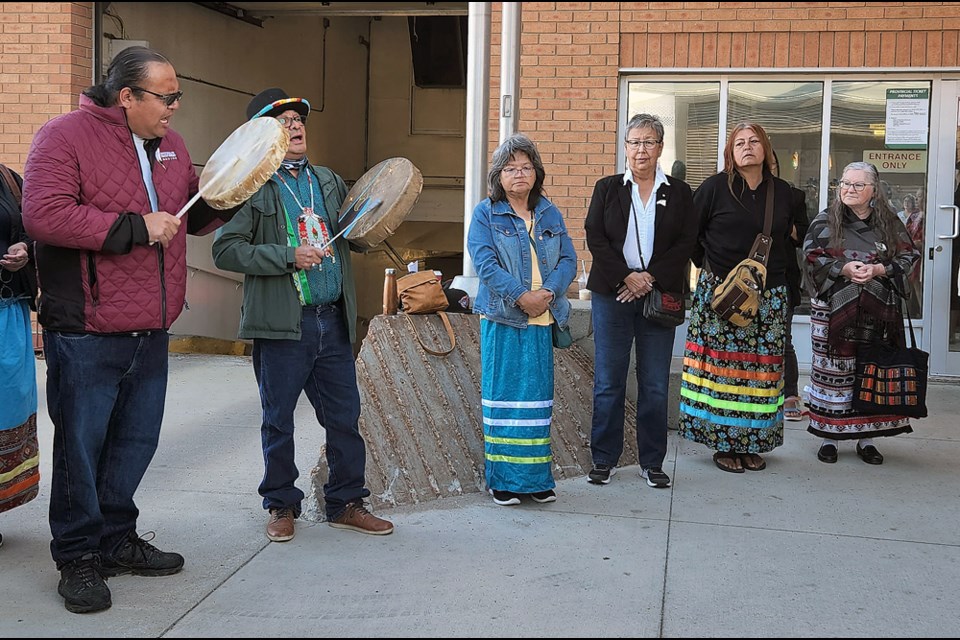 Traditional singers perform outside the Saskatchewan Provincial Court before a Saskatoon woman appears in court.