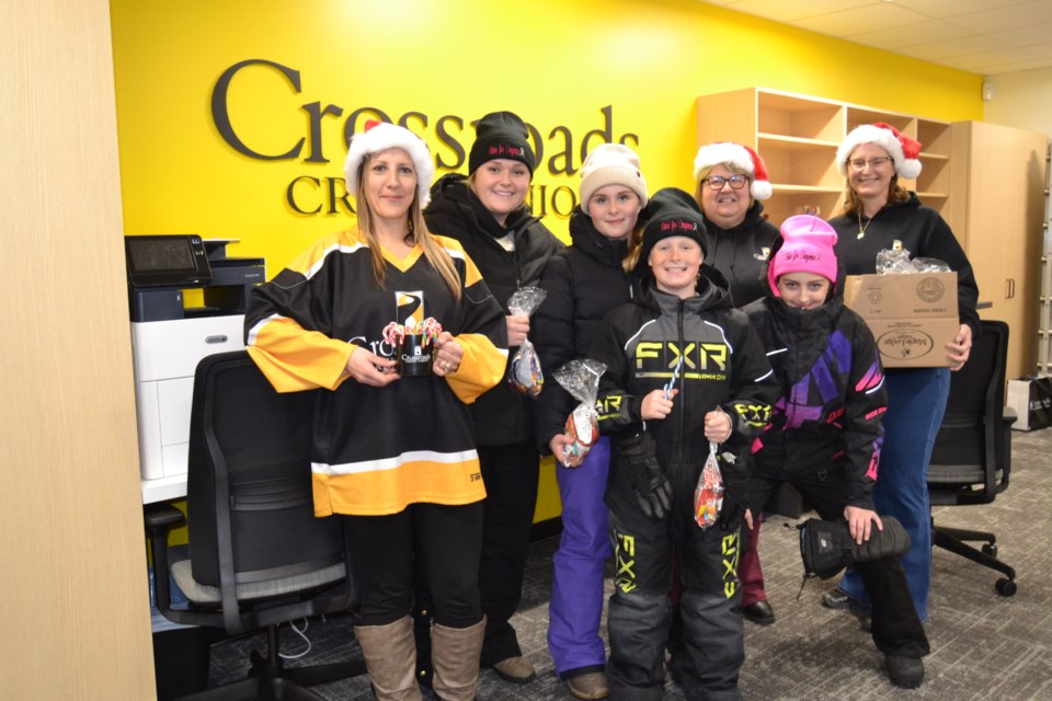 Crossroads Credit Union staff handed out candy bags and candy canes. Photographed, from left, were: Kristin Olson, Kyle Babiuk, Allie Babiuk, Koy Babiuk, Marcie Yagelnesky, Emma Olson and Kim Ryczak.