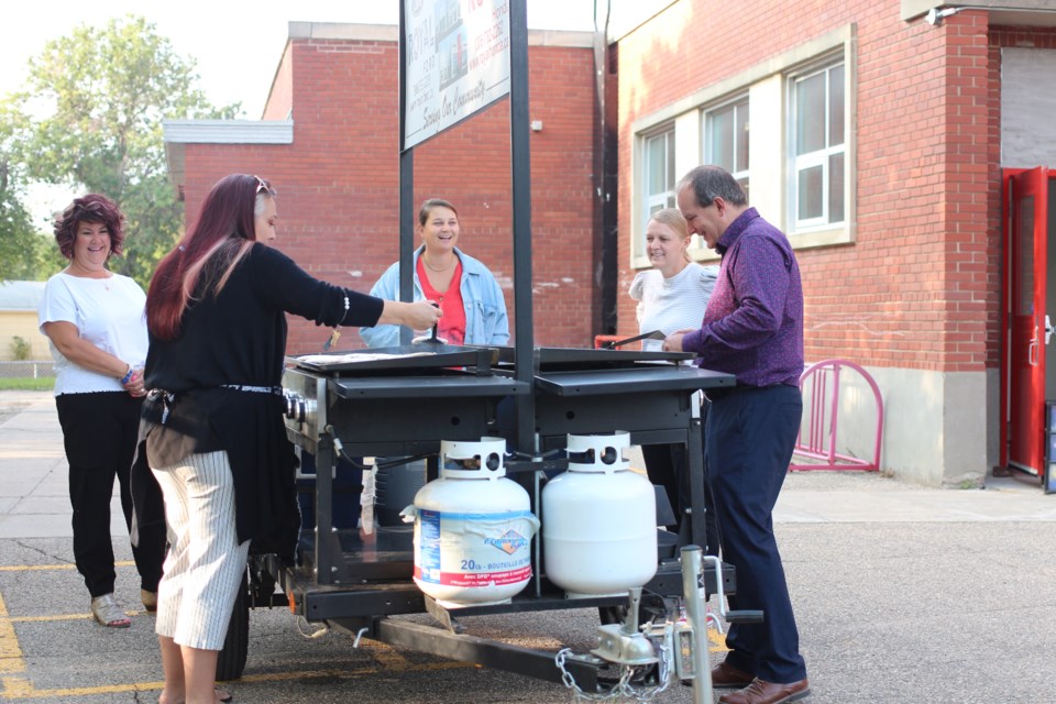 Staff from Dr. Brass cooked up pancakes for parents and students to enjoy on a grill provided by Royal Ford/Royal Honda.