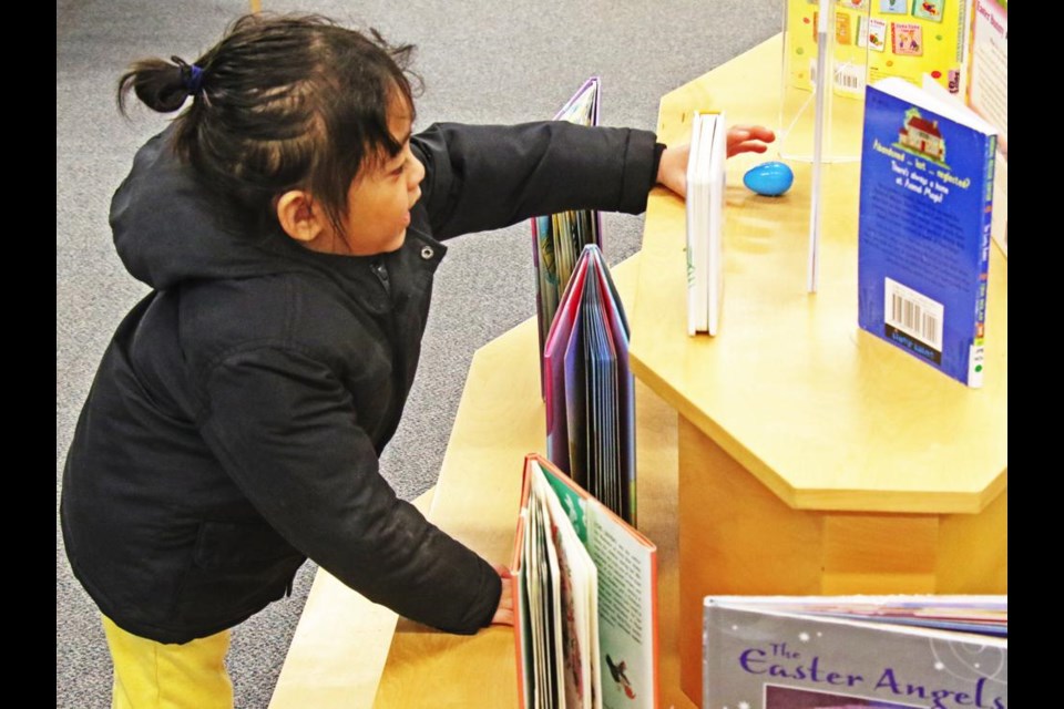 Breaden Caleb Samaniego reached for an egg, during the family Easter egg hunt at the Weyburn Public Library on Saturday morning.