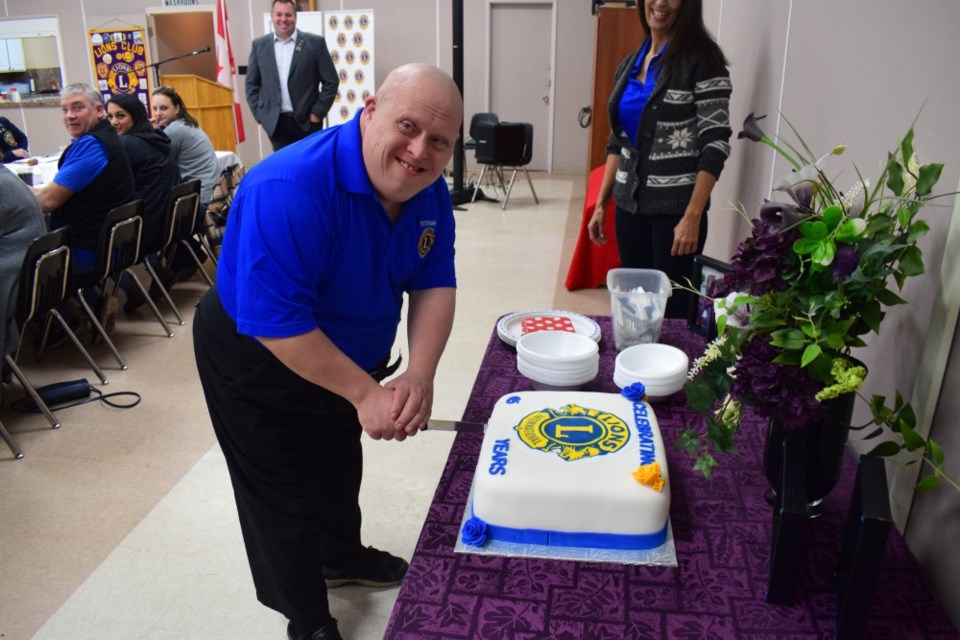 Albert Ribling cut the birthday cake. 