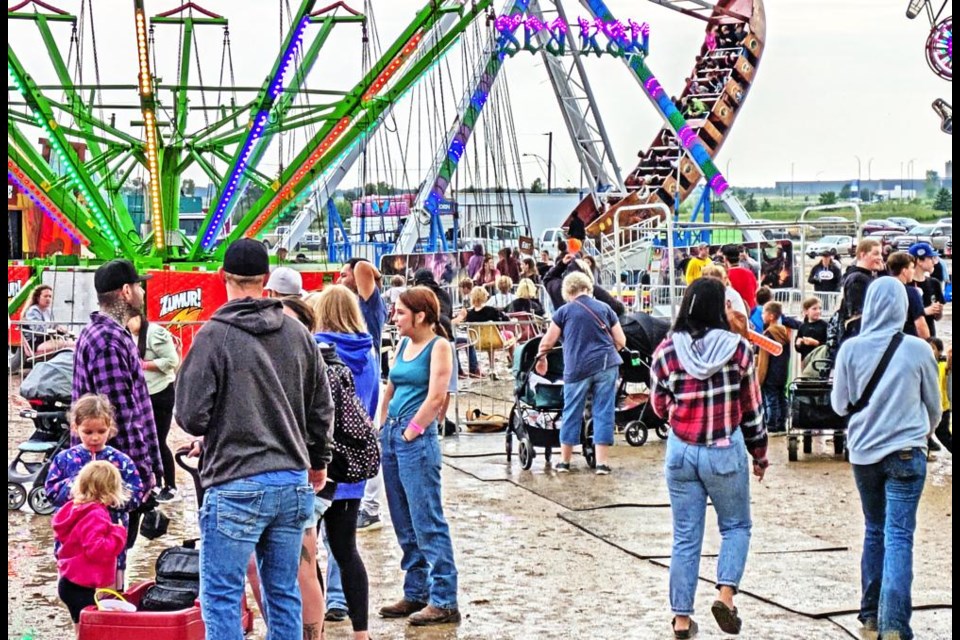 Visitors to the midway at the Weyburn Fair had to deal with muddy grounds, but were still out to enjoy the rides from Thursday to Saturday.