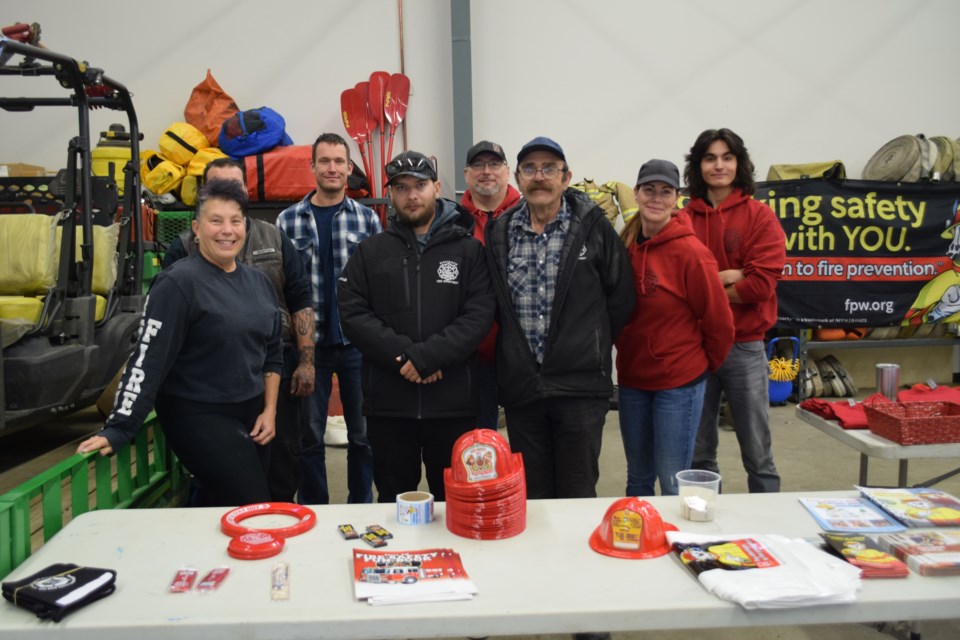 Some of the firefighters who volunteered at the pancake breakfast were from left, Sherise Fountain, Mike Covic (face obscured by Fountain), Jordan Guenther, Mike Fernuik, Andre Lamaroux, Fire Chief Ken Thompson, Pam Rose, and Chase Fountain.