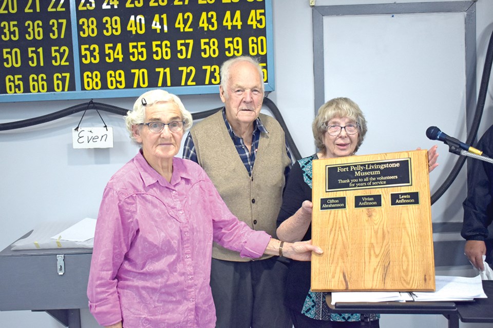 Sylvia Abrahamson, Merv Abrahamson, and Donna Abrahamson showcased the plaque which honours the late Clifton Abrahamson for his volunteer work in Pelly.