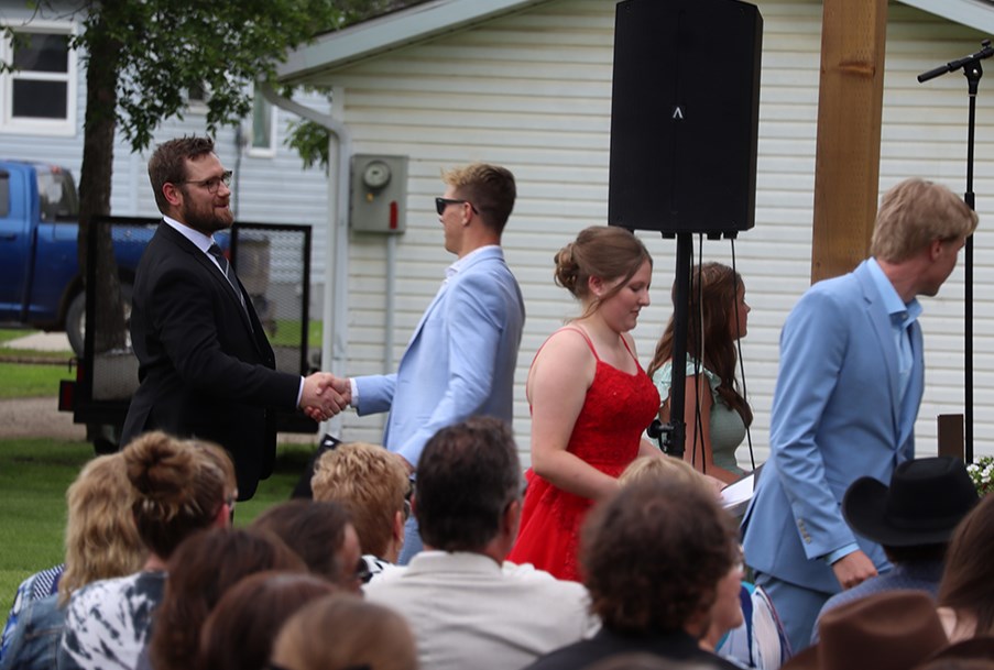 On their way off the stage, graduates received their scrolls from CCS Vice-Principal Derek Serdachny (soon to be principal).