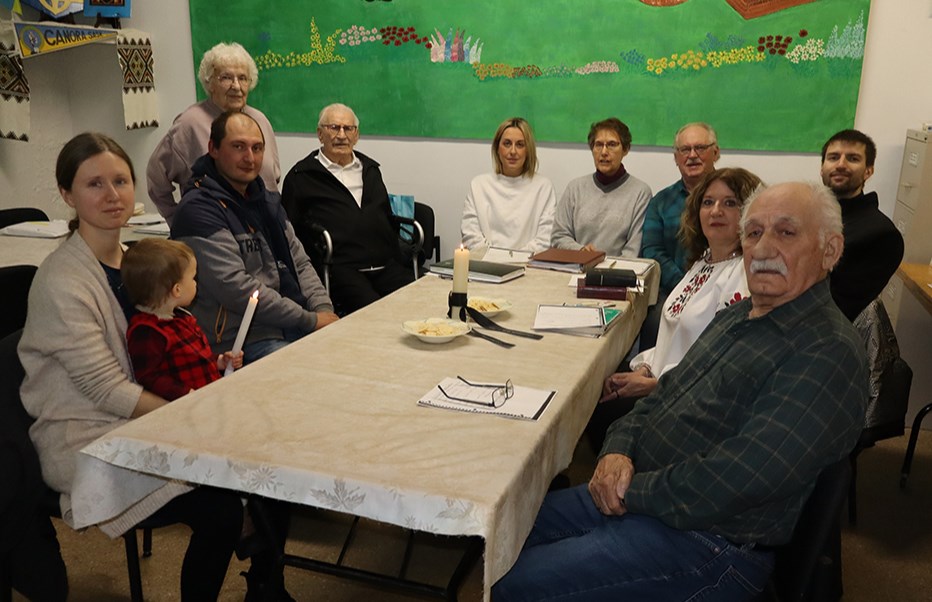 Served only crackers and tea, members of the Ukrainian Canadian Congress, Canora Branch remembered and paid tribute to those who suffered during the Holodomor in Ukraine in 1932-33. Those in the midst of the Holodomor would have likely considered themselves fortunate to receive this meagre meal. From left, around the table, were:  Dobr. Lesia Simko holding Damian Simko, Vasyl Mazur, Dorothy Korol, Terry Korol, Amanda Zbitniff, Audrey Hrycak, Harold Woloschuk, Fr. Ivan Simko, Denise Leslie and Bernard Marchinko.