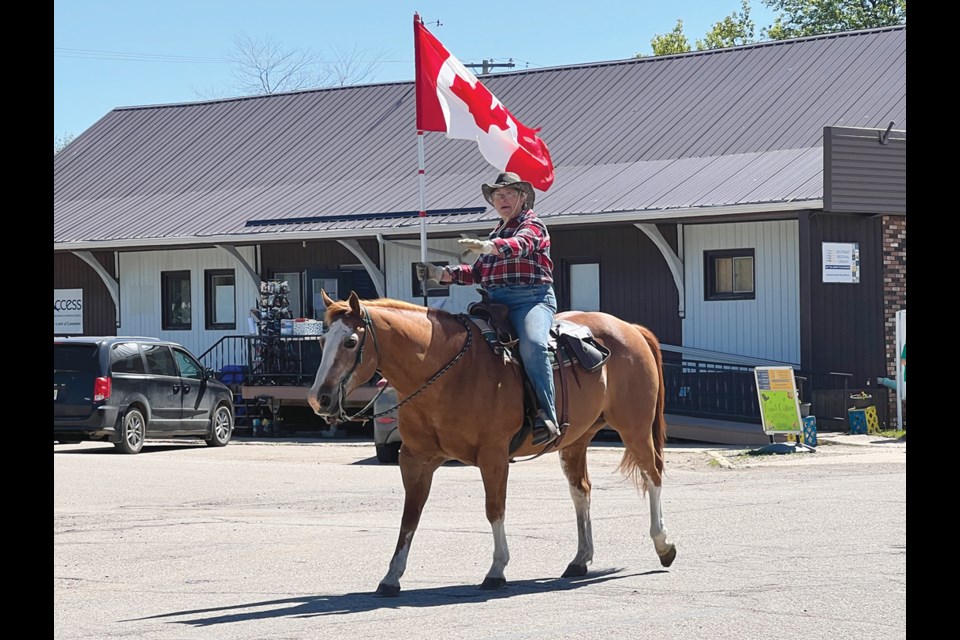 A single horse and rider carrying the Canadian flag came the RCMP truck to start the parade in Lampman. 