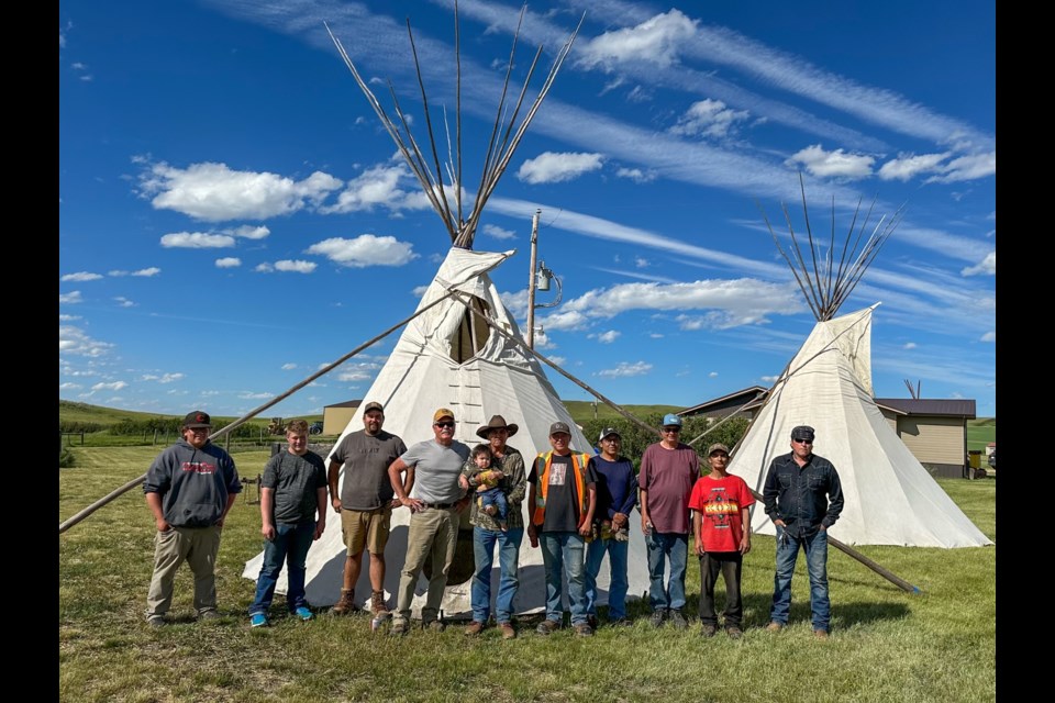 A tipi was set up and displayed during the event. From left are James Ogle, Kenneth Doherty, Colton Ogle, Elder Larry Mckay, Alejandro Ogle (baby), Matt Ogle, Ross Lethbridge, William Ferguson, Morris Nokusis, and Corey Yellow Boy.