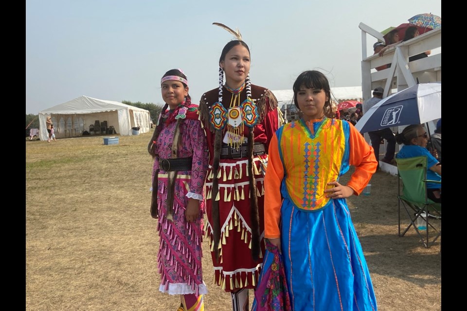 Young jingle dress dancers in festive regalia shown at the powwow Friday.