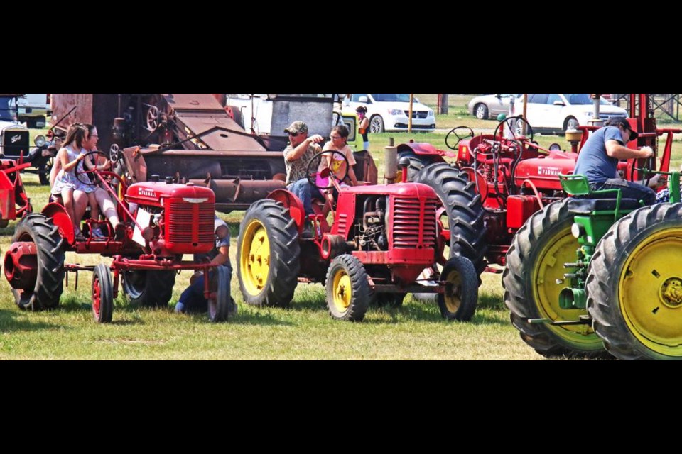 Volunteers prepared for driving some of the old tractors in the parade for the Pioneer Echoes days in Midale on Saturday.