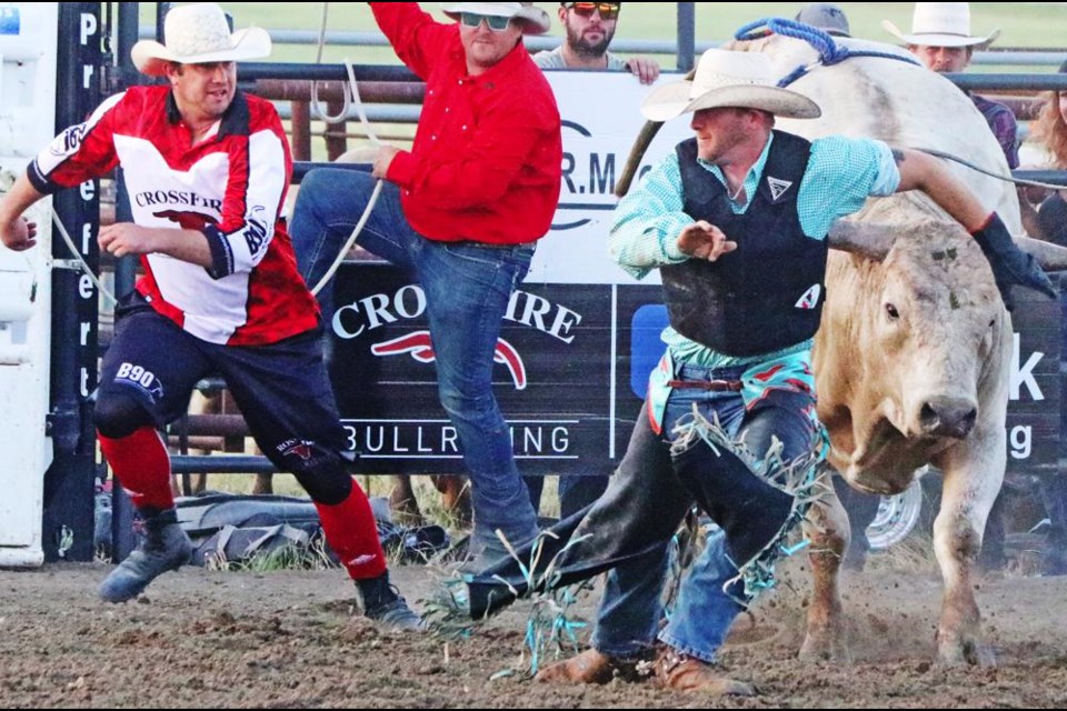 It was time to run for Chris Graham of Winnipeg, with the help of a rodeo clown, after getting bucked off at the Midale Bull Bash on Friday evening.