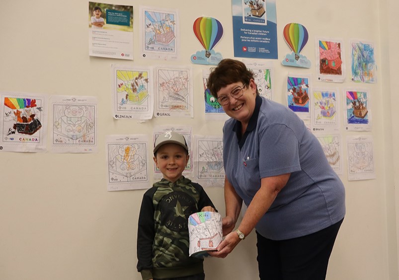 Five-year-old Wyatt Owchar was in charge of proceedings at the Canora Post office for its Community Foundation prize draws on June 5. He was assisted by Lori Negraeff of the post office. 