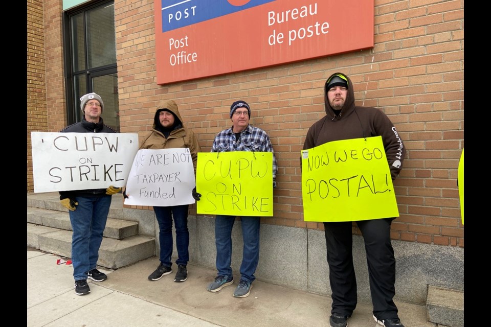 Postal workers join the picket line outside the post office in North Battleford. 