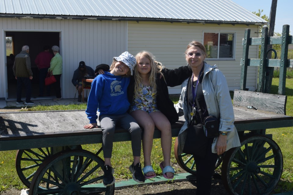 From left, Wilder Lawless, Lexie Derwores, and Jan Derwores enjoyed the museum’s opening activities and the sunny day.