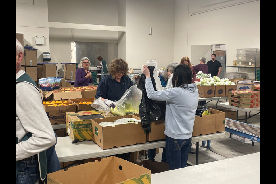 Volunteers help prepare the food that is then later sent out.