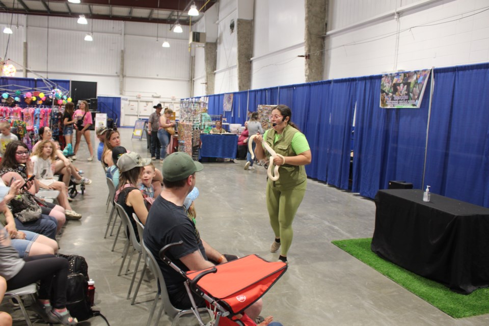 Wilke, pictured here with a snake, one of many of her ambassador animals.