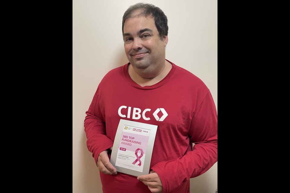 Aaron Nagy, a customer service representative at the CIBC branch in Canora, posed for a photo with his award for being the third top fundraiser at the CIBC Run For The Cure on Oct. 1 in Regina. Nagy and about 600 other runners braved the wind and the rain to raise over $216,000. Nagy’s final total raised was $7363.60.