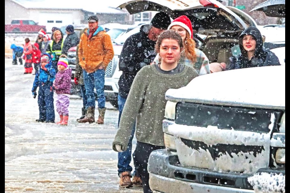 Families waited for the parade to arrive as wet snow fell, creating slushy conditions on the streets on Saturday.