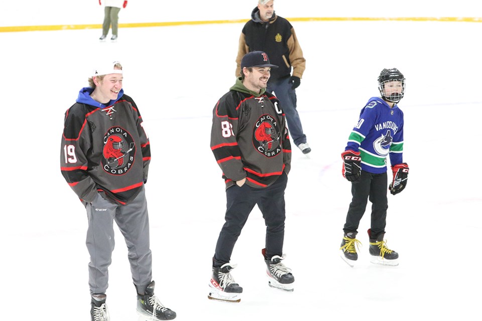 A number of players from the Canora Cobras senior hockey team threw on their jerseys and joined the fun at Skate with Santa. From left, Logan Wolkowski and Captain Ryley Stefanyshyn of the Cobras shared a smile with a young skater.

