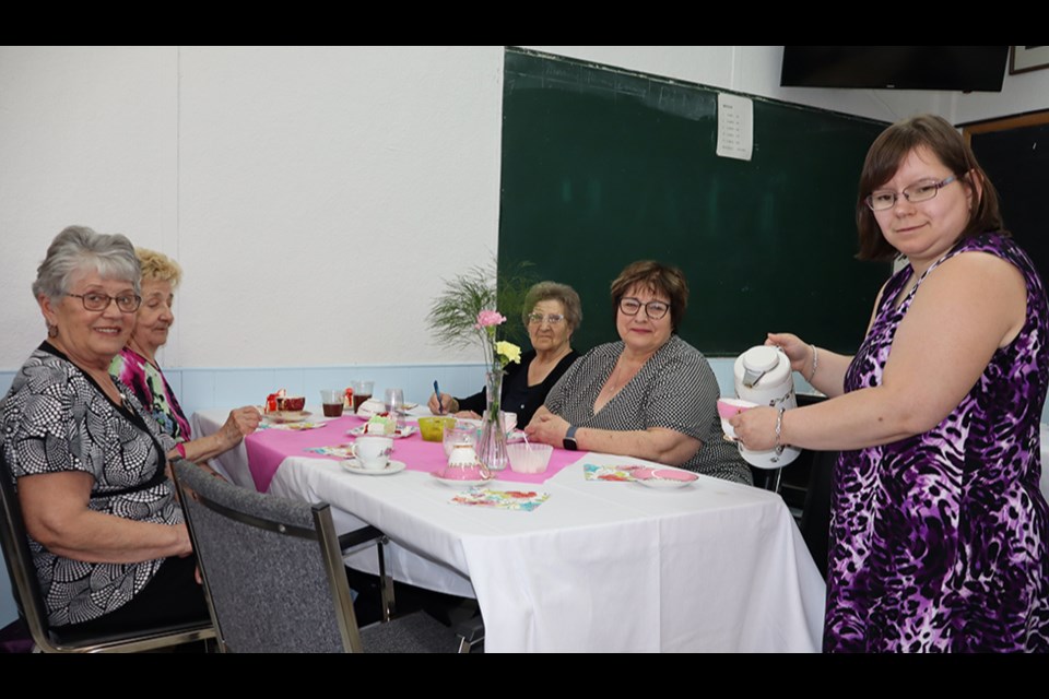 From left: Marlene Kozak, Floreen Haskewich, Victoria Ryczak and Cynthia Gazdewich enjoyed the Canora Hospital Auxiliary Spring Tea on May 11 at the Keen Age Centre, while Jaimie Wasyliw provided friendly service.