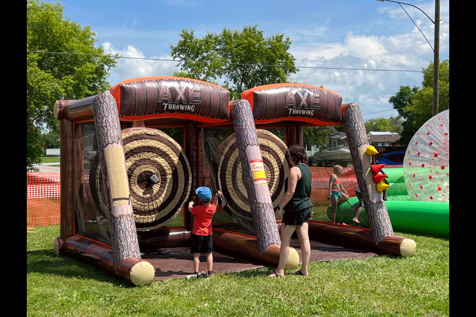 Cutline 1: The axe toss was a popular event for young and old while proving to be more difficult than one might think. 