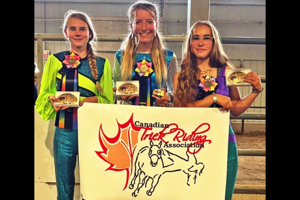 Truco riders Bailey Steeves, Jordanna White and Shayda King show the awards they won at the Canadian Trick Riders competition held in Ft. Macleod, Alta., on Aug. 22-23.