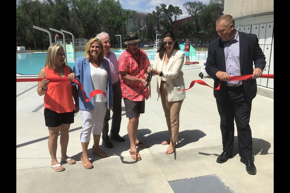 Mayor Sandra Masters and Minister of Government Relations Don McMorris cut the ribbon to officially open the new Wascana Pool.