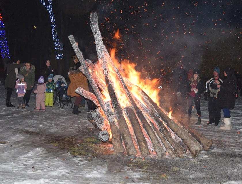 The big bonfire drew many visitors, with some just looking to  warm up a bit.