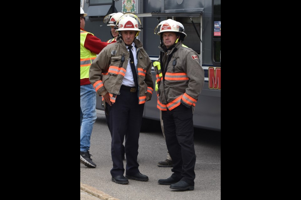 Battalion Chief Sean Thody, right, updates Saskatoon Fire Department Chief Morgan Hackl.