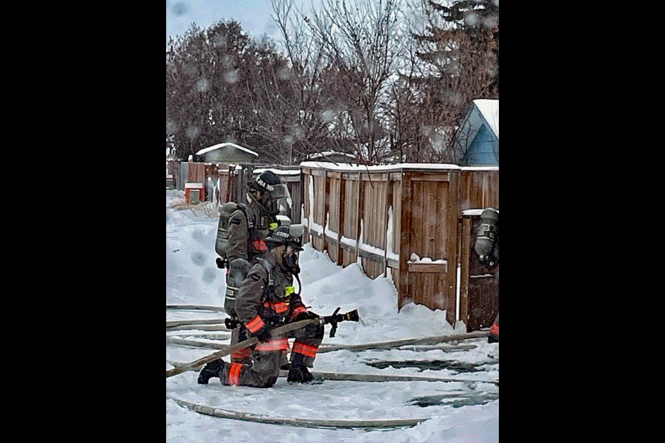 Saskatoon firefighters prepare to hose down the detached garage on Richardson Road in Saskatoon on Monday, Dec. 19.