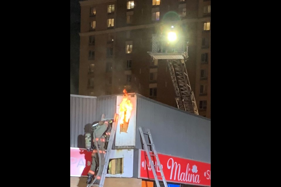 Fire crews attend to the fire in a strip mall near Downtown Saskatoon Saturday evening.