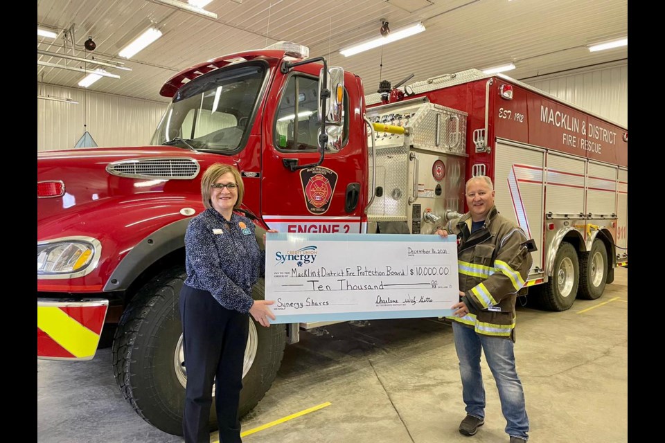 Synergy Credit Union Branch Manager, Charlene Walz-Gette, presents a $10,000 cheque to Macklin Fire Department Chief, Justin Bast, representing the Macklin Fire Protection Board.