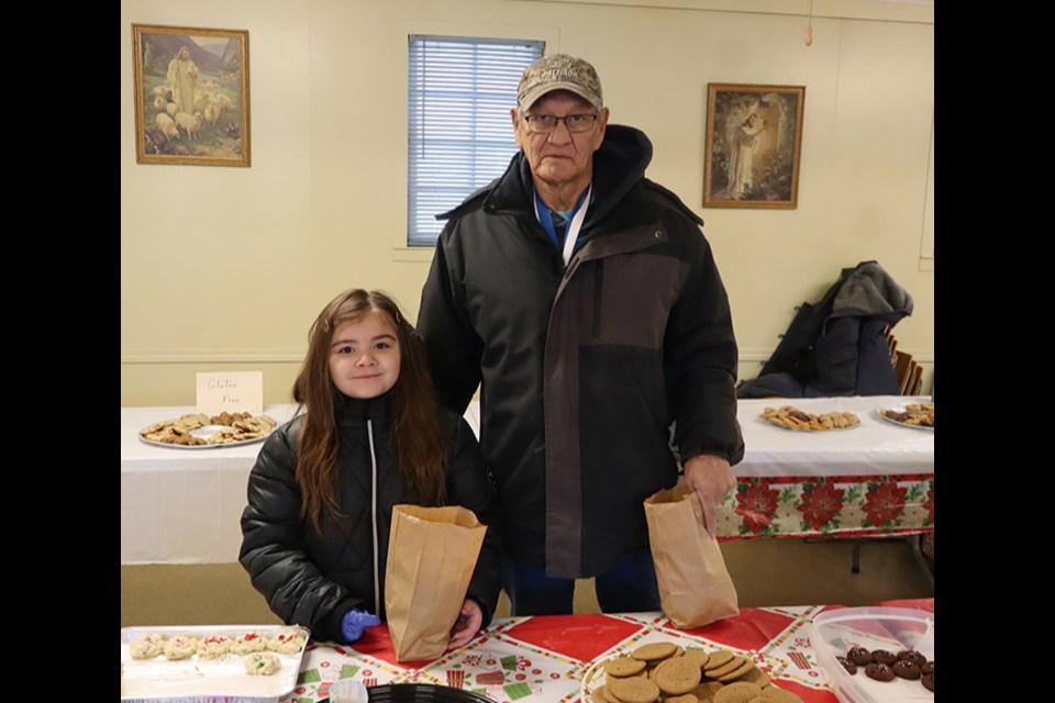 Riley Severight brought her grandpa, Lloyd Brass, to the United Church Cookie Walk on Nov. 30, and had a hard time deciding which cookies to choose to fill her bag. Brass added, “It’s great to have lots of cookies for the grandkids for Christmas.” 