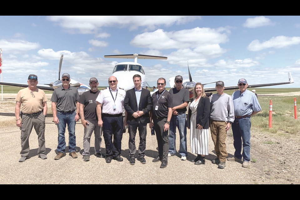 A strategic display open house was held at the Assiniboia Airport. From left are Peter Kordus, Chris Sinclair, Clint Engstrom, Dan Kinsley, Evan, David, Bob Ellert, Sandy Ellert, Graham Harvey and Grant Payant.