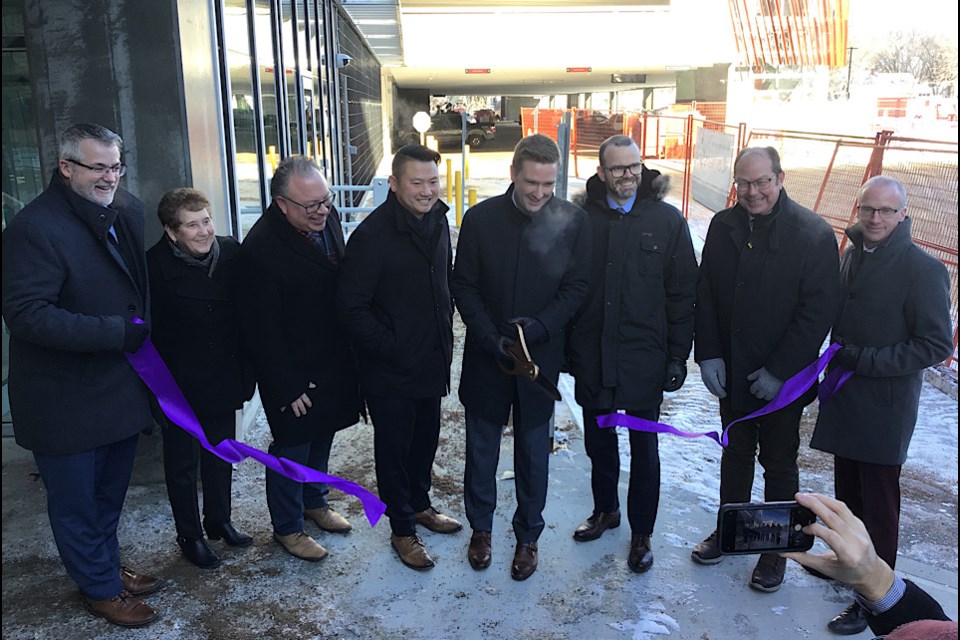 Health Minister Jeremy Cockrill cuts the ribbon on the new Regina General Hospital parkade along with dignitaries and officials.