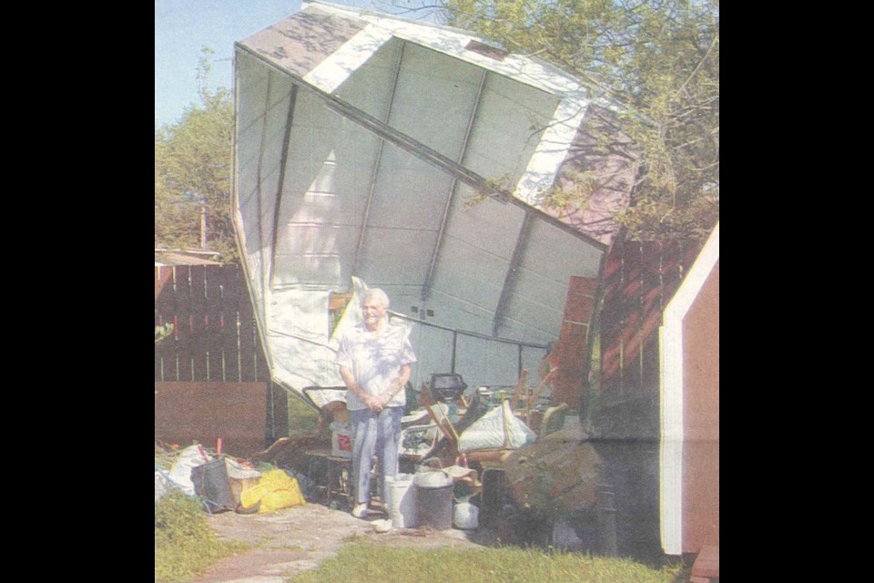 Unity resident Freda McCallum stands inside where her shed used to be before a storm slammed Unity. 